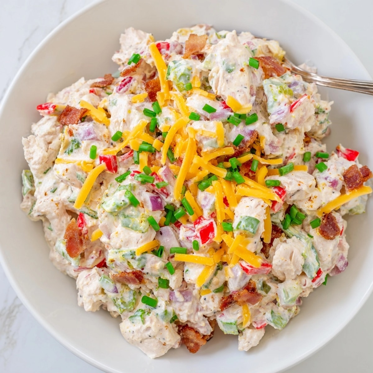 Creamy Jalapeño Popper Chicken Salad with melted cheddar and crispy bacon crumbles.