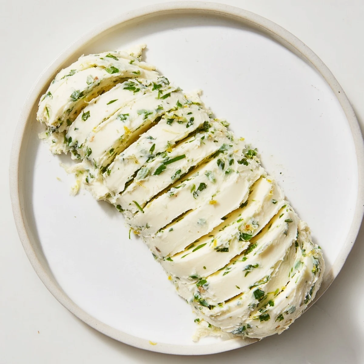 Glorious garlic herb butter melting over a juicy steak, seasoned with fresh herbs.