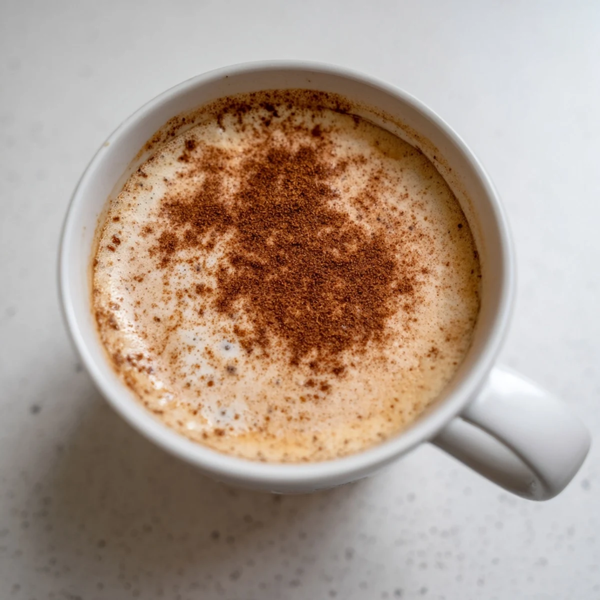 A warm mug of Spiced Chai Latte, spices swirling, a delicious and cozy drink to savor.