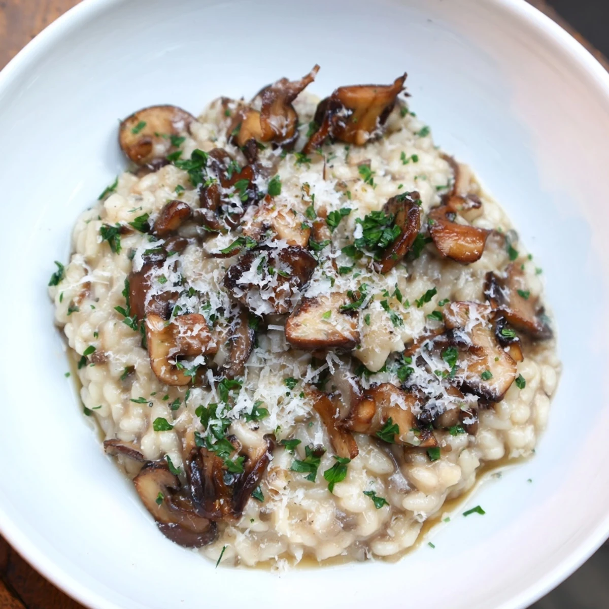 Close-up of golden Mushroom Risotto, showing the creamy texture and earthy mushrooms.