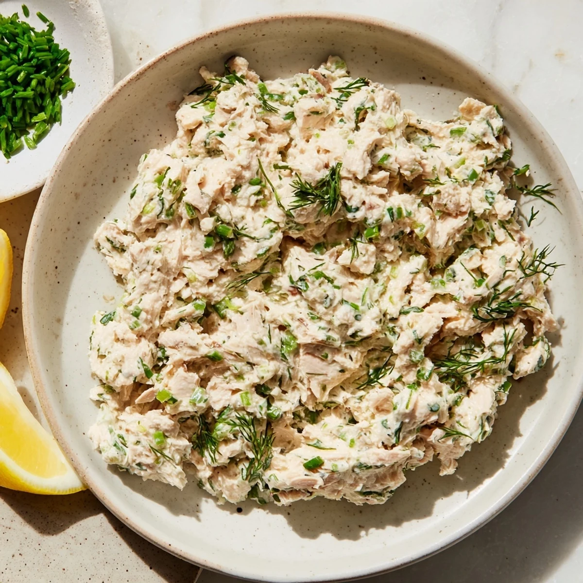 Bowl of delicious, creamy smoked mackerel pâté with fresh herbs on golden toasted bread.