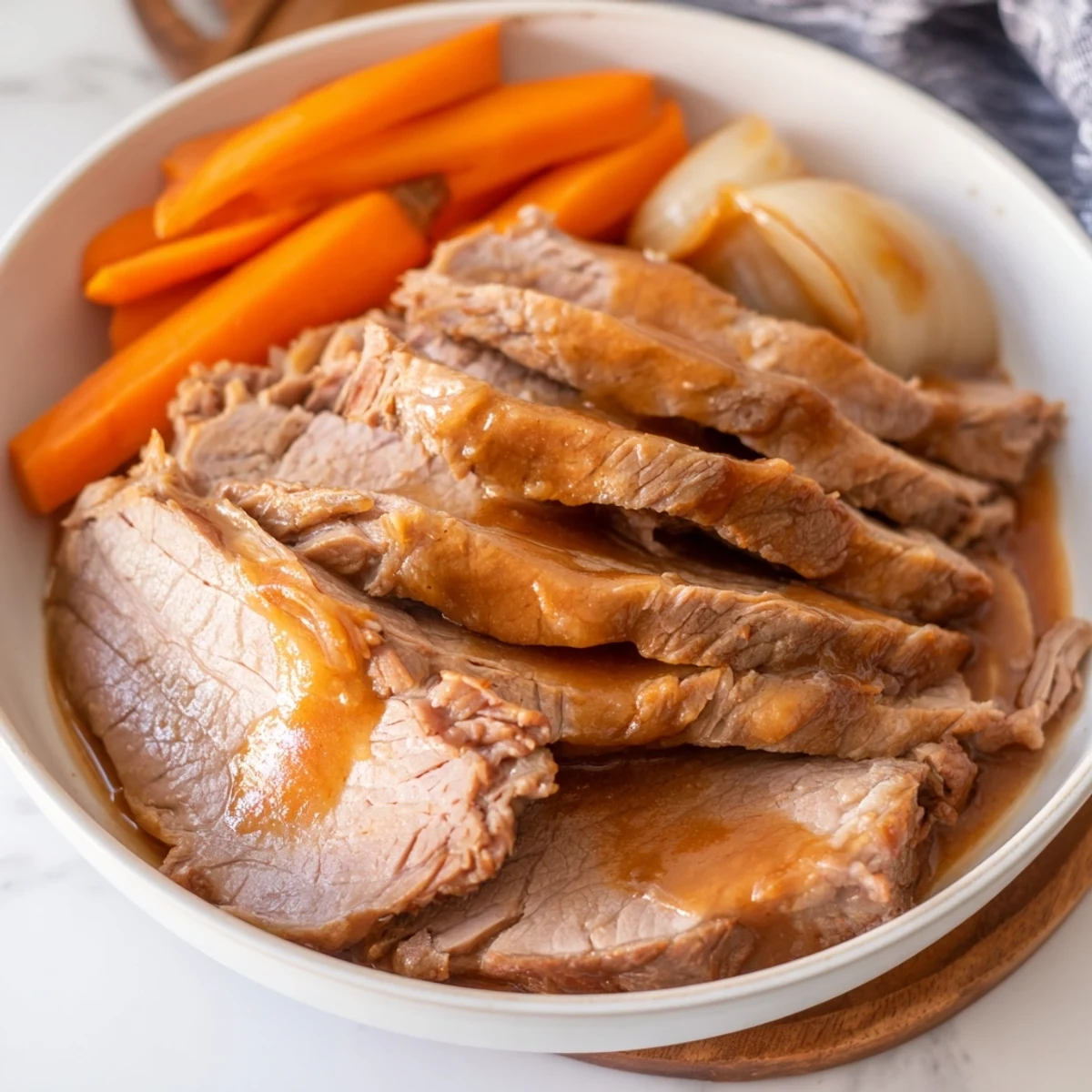 Mouthwatering, juicy slices of slow cooked brisket, perfect for a cozy family dinner.