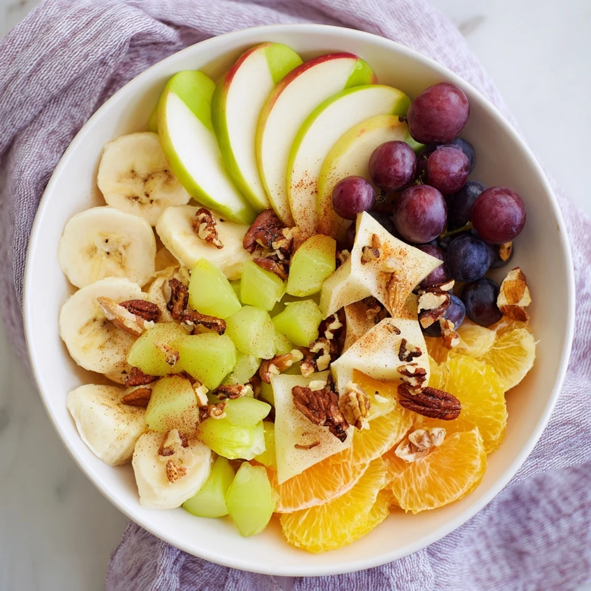 Warm fruit salad glistening with honey, cinnamon, and nutmeg, perfect for a cozy dessert.