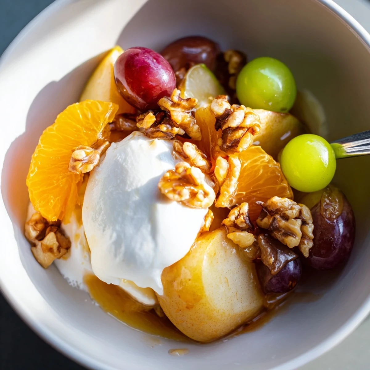 Spiced Fruit with Cinnamon simmering in a saucepan with golden apple wedges and aromatic star anise.