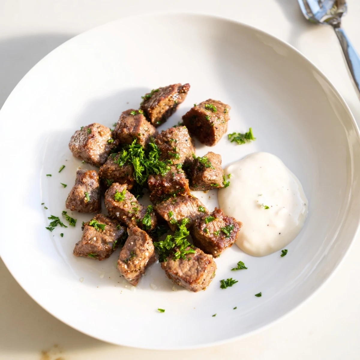 Tender, juicy sirloin cubes in a rich garlic butter sauce, paired with a dollop of zesty horseradish cream for a perfect steakhouse appetizer.  
