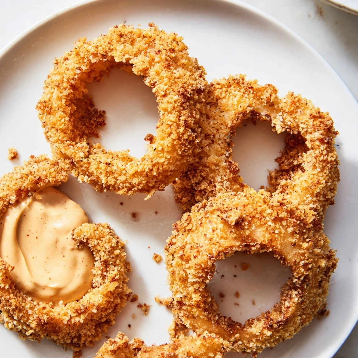 Crispy Air Fryer Onion Rings with Chipotle Mayo are golden and crunchy, served hot for dipping.