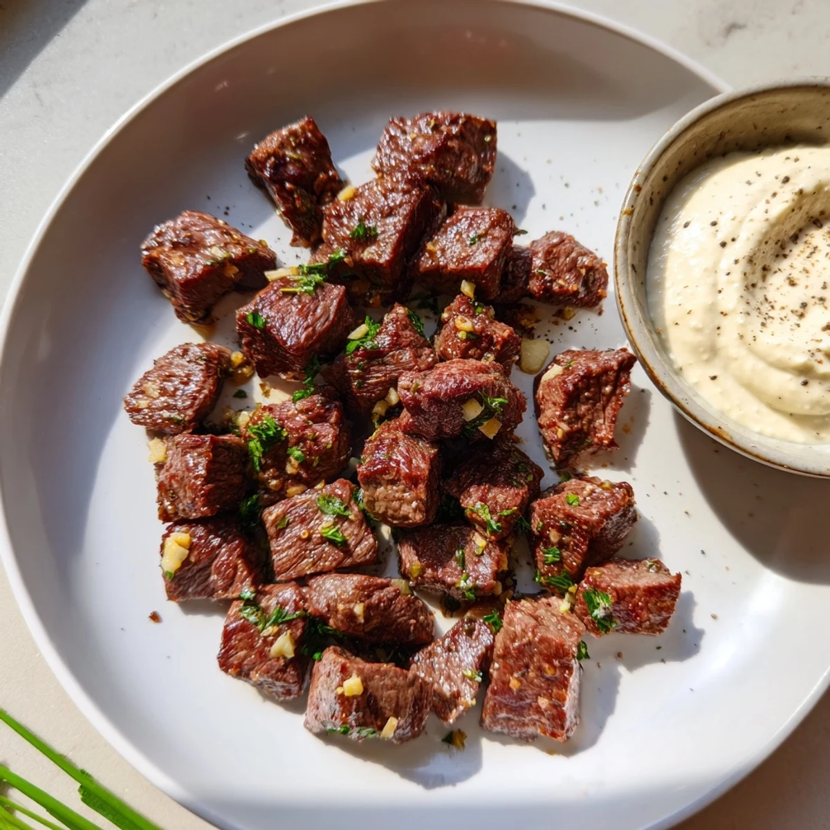 Juicy Garlic Butter Steak Bites sizzling in a skillet with melted butter and minced garlic, ready to be served.