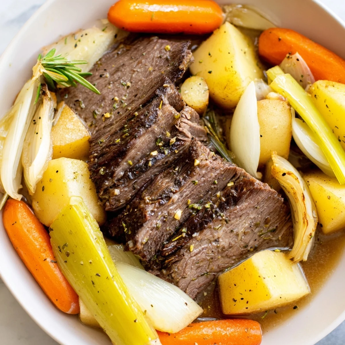 Golden-brown Slow Cooker Beef Pot Roast with Root Vegetables surrounded by soft carrots, parsnips, and celery on a platter.