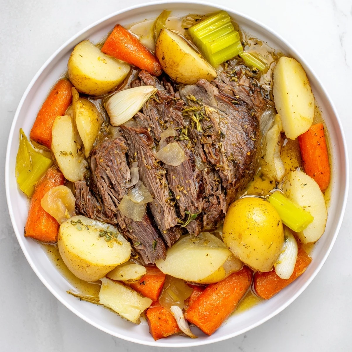Hearty Slow Cooker Beef Pot Roast with Root Vegetables, garnished with fresh thyme and spoonfuls of rich, aromatic sauce.