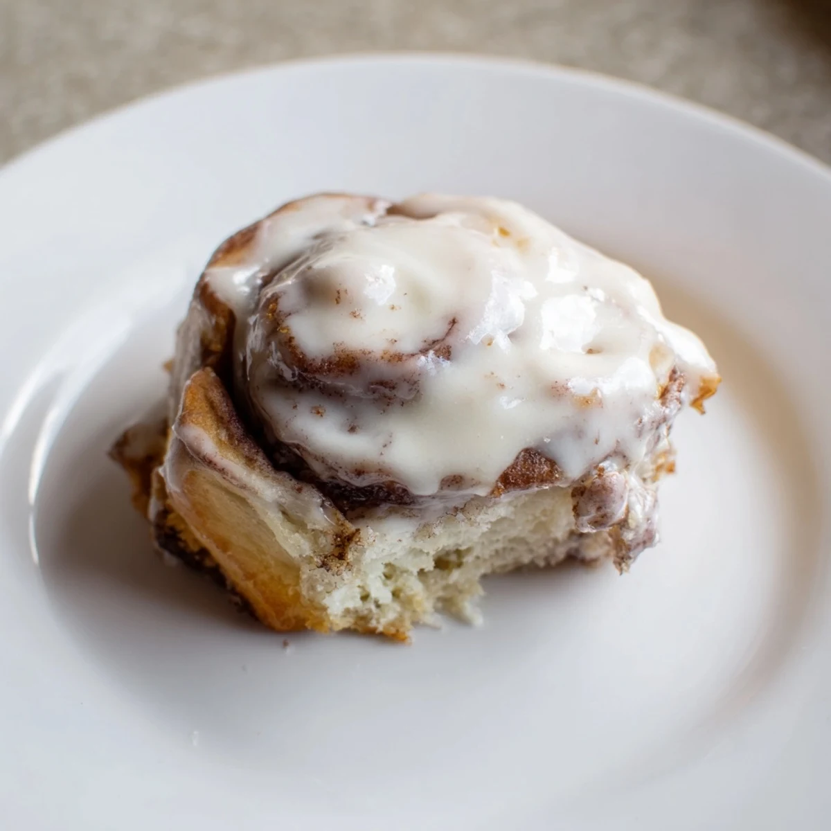 Freshly baked Keto Cinnamon Buns are arranged on a plate, ideal for a keto-friendly dessert or snack.