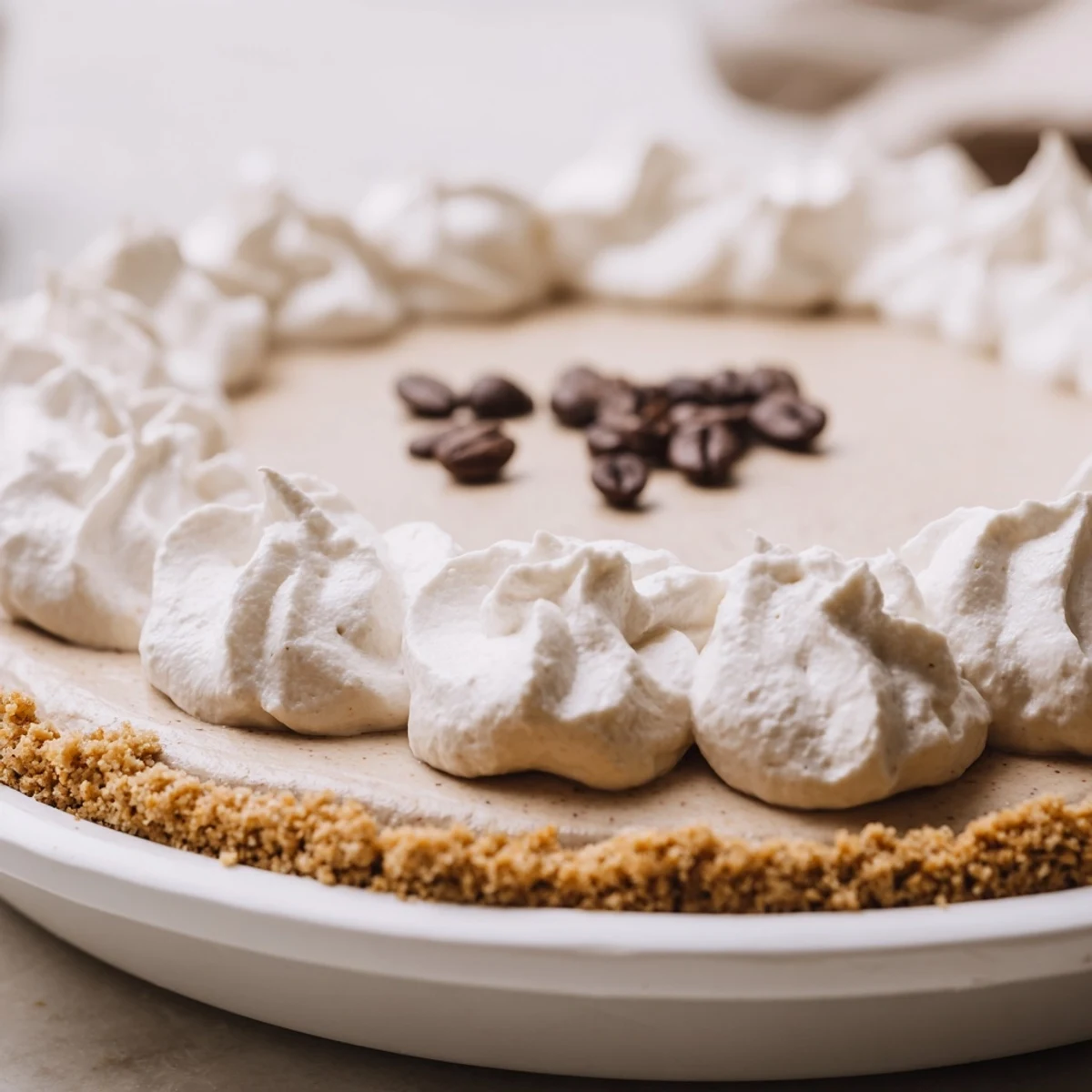 This no-bake Keto Cold Brew Coffee Pie features rich coffee flavor in a creamy filling, set in a crisp gluten-free almond crust.
