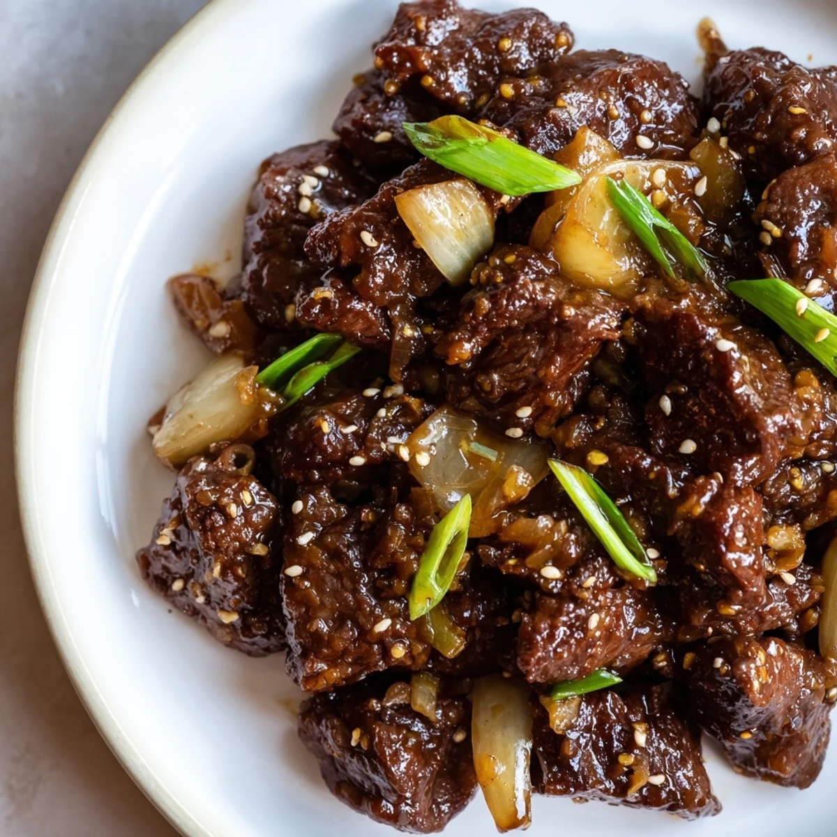 Tender beef cubes glazed in a sticky, spicy-sweet sauce from this Crock Pot Korean Beef recipe, served over steamed rice.  