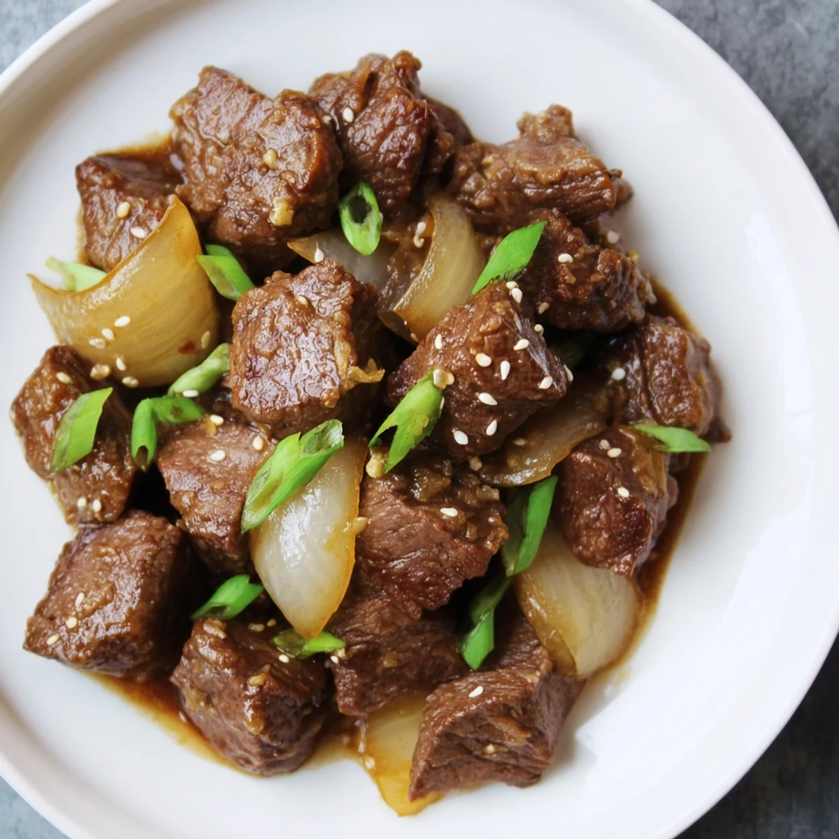 A close-up view of a savory Crock Pot Korean Beef garnished with green onions and sesame seeds, with steam rising from the slow cooker.  