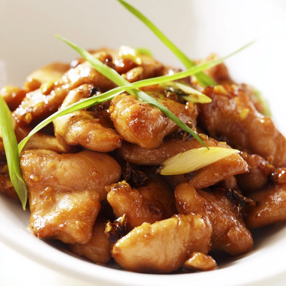 Steamed jasmine rice and cucumber slices alongside Vietnamese Lemongrass Chicken.