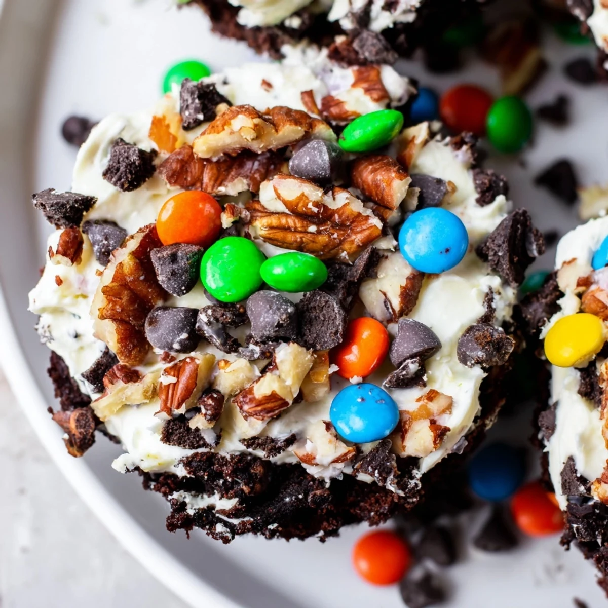 Decadent loaded brownie cheesecake cups with swirls of creamy vanilla filling and crunchy toppings