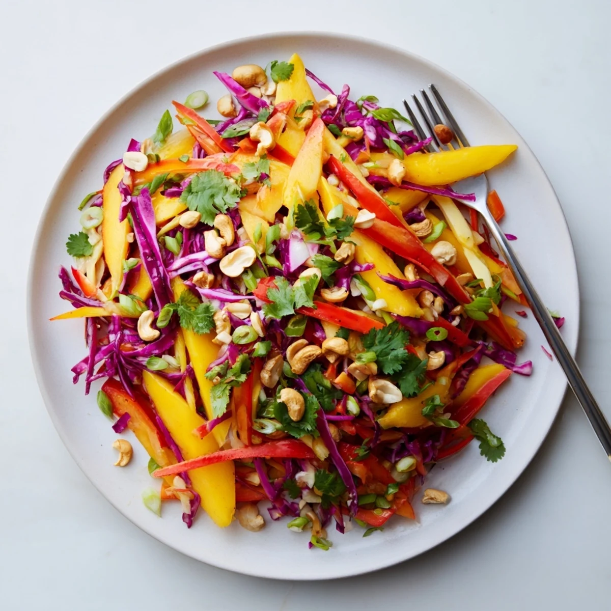 Colorful mango slaw with crisp red cabbage, carrots, and tangy lime dressing