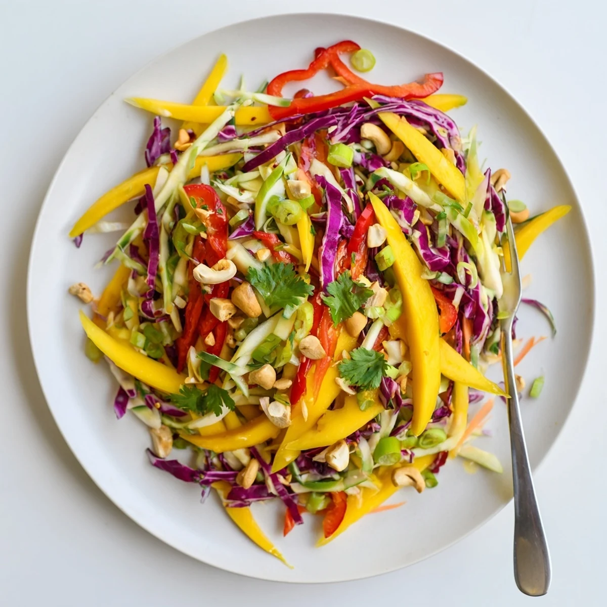 Vibrant tropical mango slaw with julienned vegetables and creamy honey lime dressing