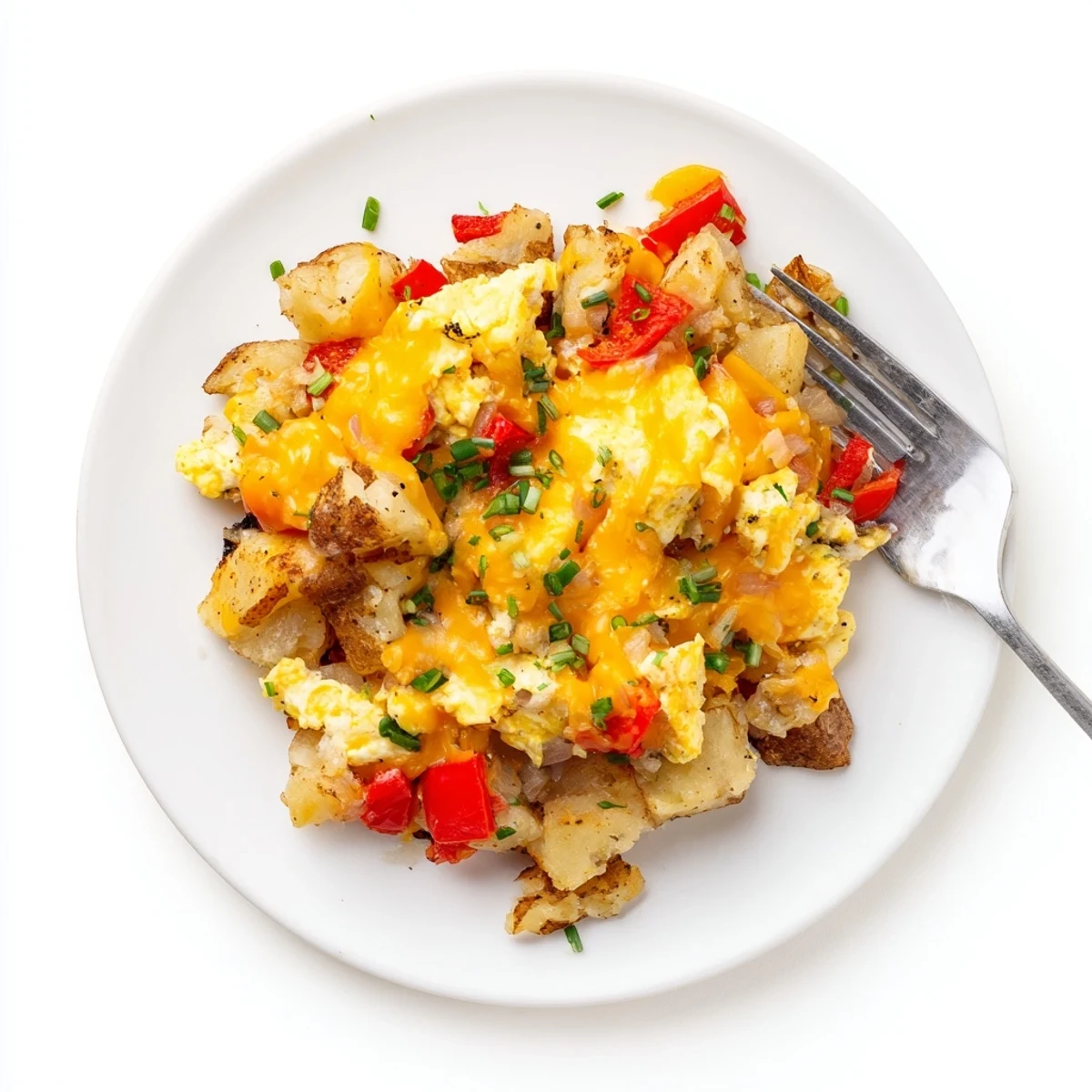 Creamy cheesy potato egg scramble featuring golden brown potatoes and tender bell pepper pieces