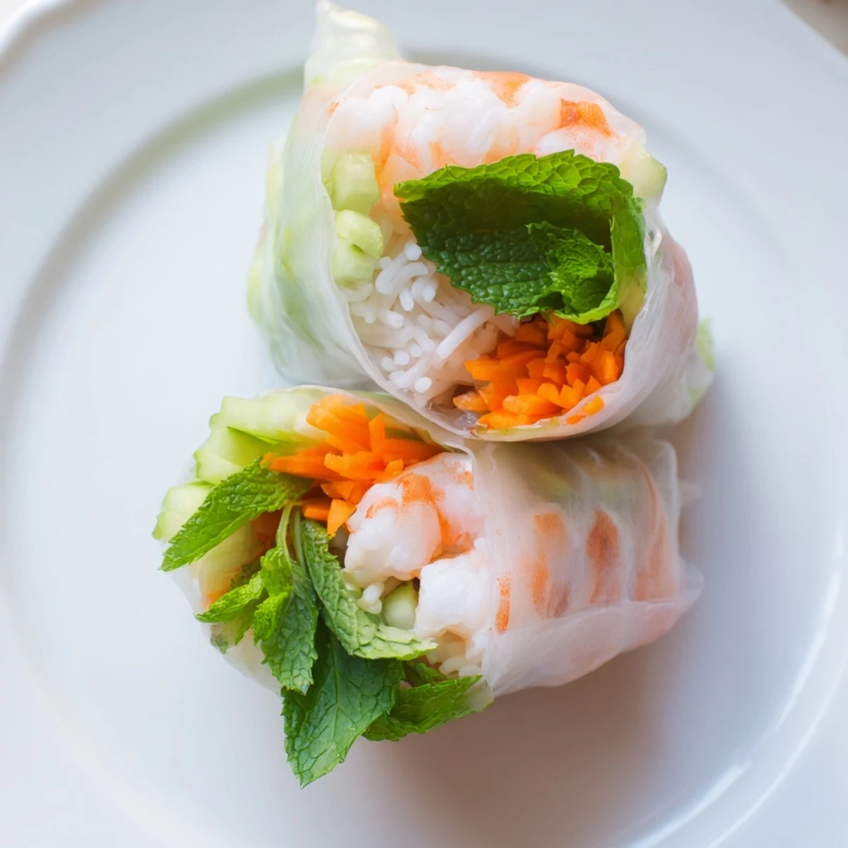 Vietnamese fresh spring rolls with peanut sauce showcasing translucent wrapper filled with colorful julienned vegetables and herbs