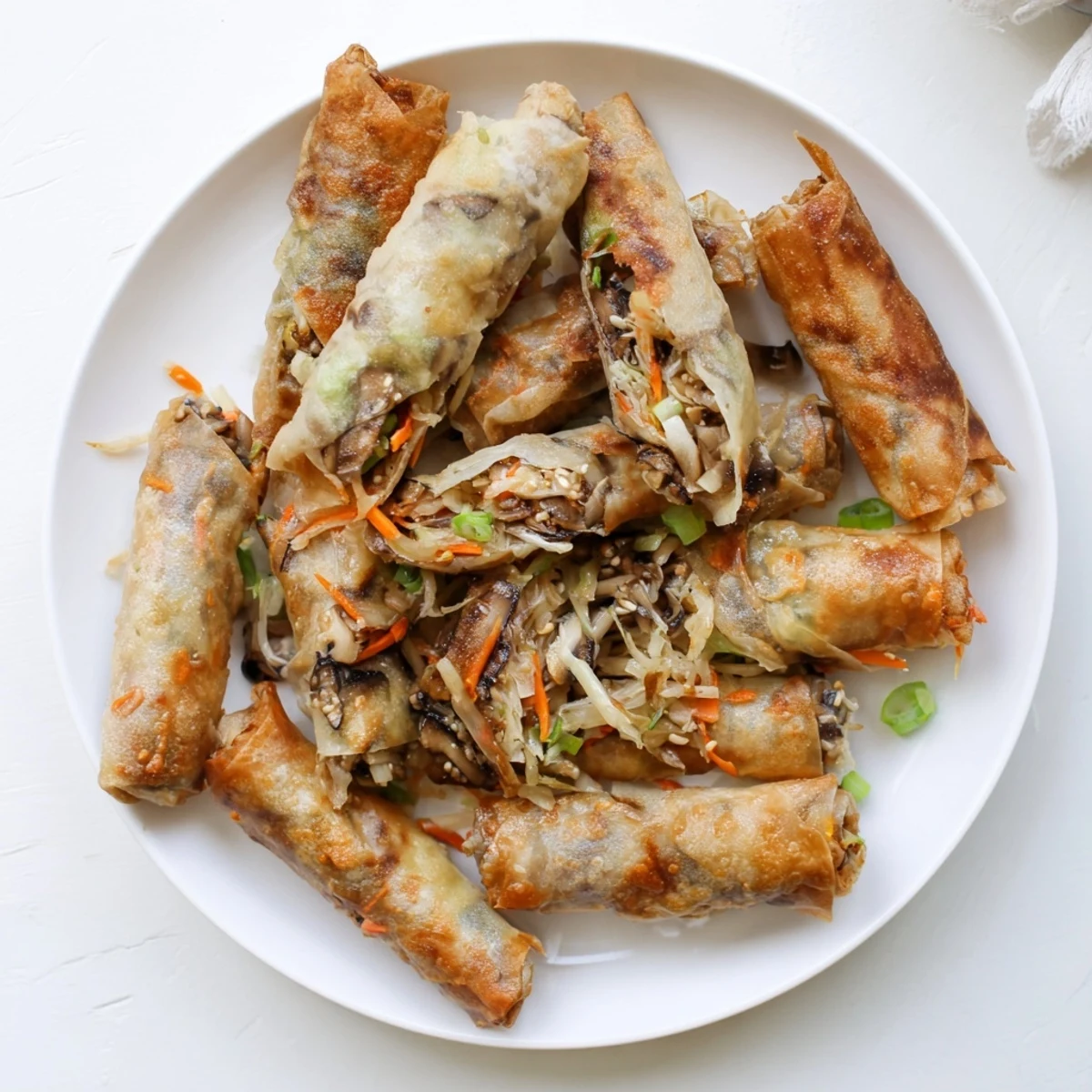 Fried rice paper spring rolls displaying crunchy texture and shredded vegetable filling visible