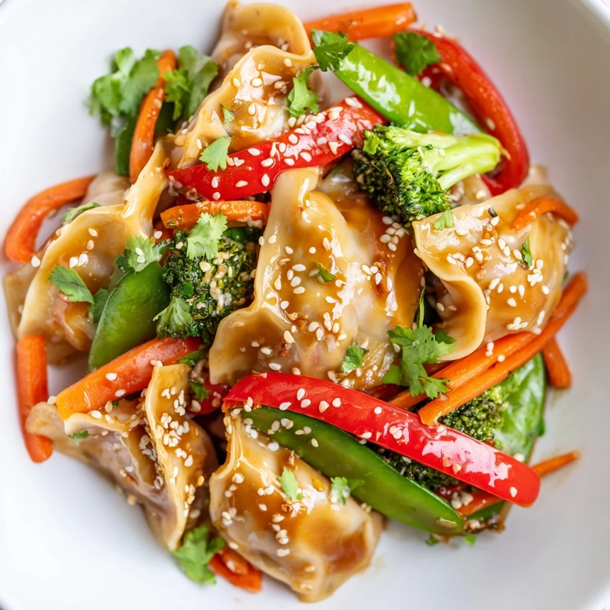 Tender vegetable dumplings tossed with broccoli and peppers in savory Asian-style garlic glaze