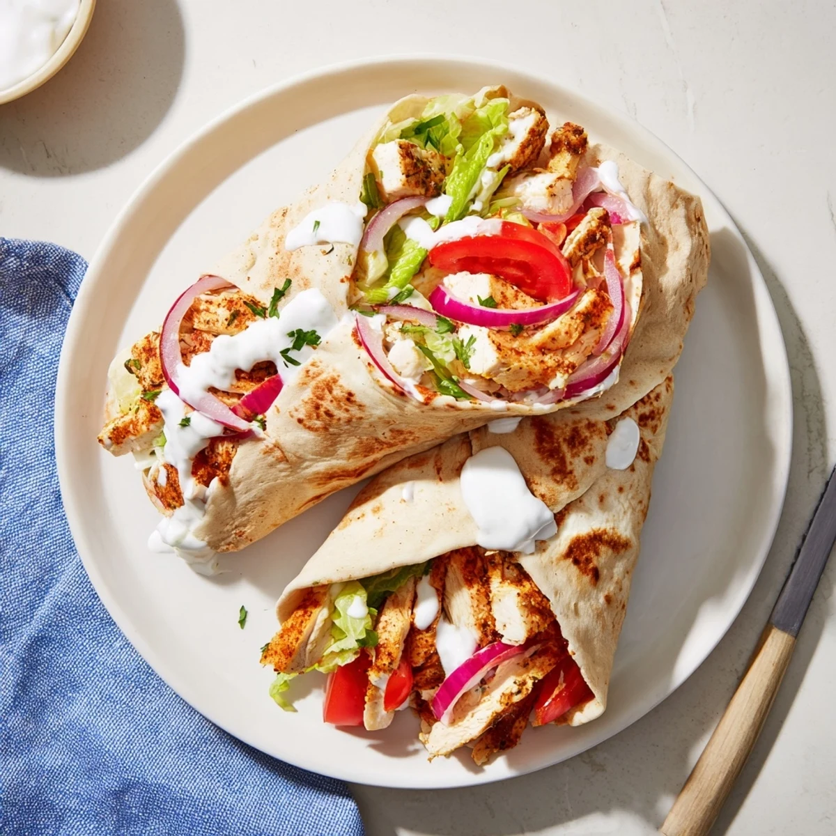 Golden cottage cheese flatbread wrapped around spiced grilled chicken with fresh vegetables