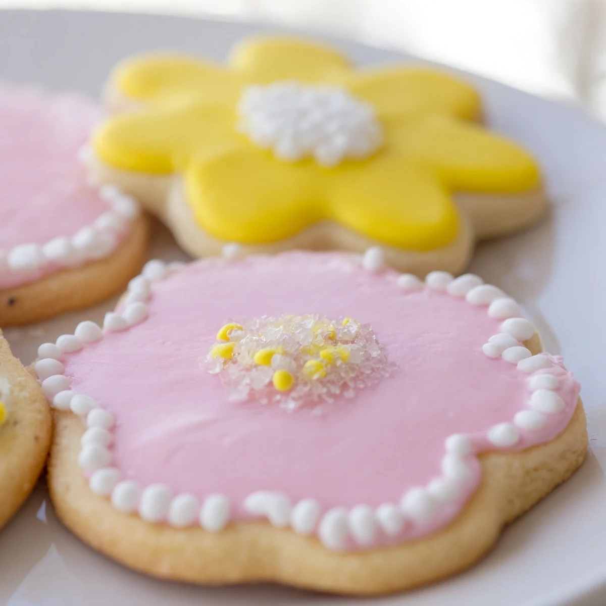 Chewy Spring Easter cookies adorned with soft pastel icing and festive rainbow sprinkles