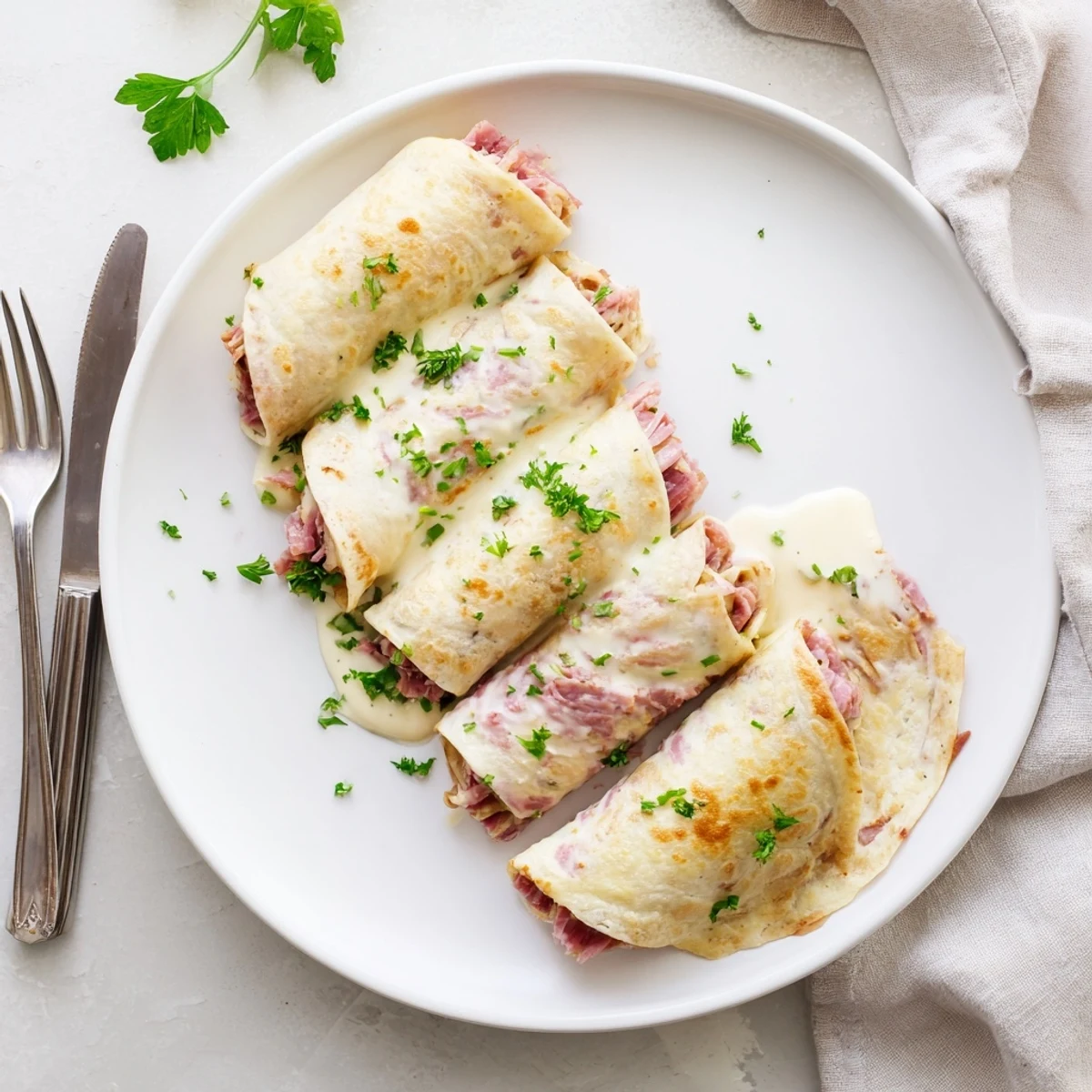 Tender egg wraps rolled with tangy sauerkraut and savory corned beef in Low Carb Reuben Egg Roll Ups