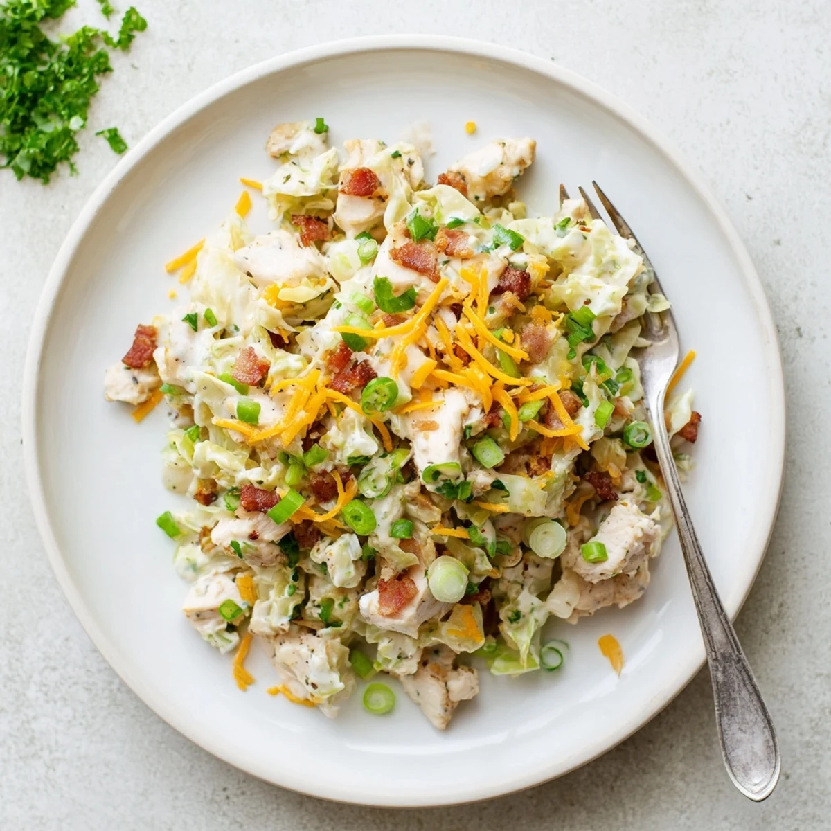 Rustic bowls of chicken bacon ranch cabbage featuring crunchy vegetables and melted cheese toppings