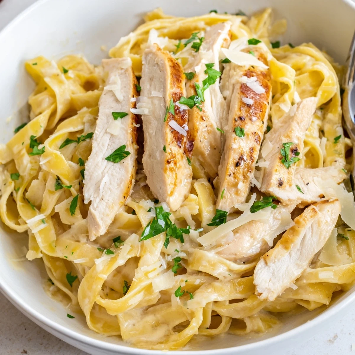 Weeknight ready Creamy Garlic Chicken Pasta served with crusty bread nearby