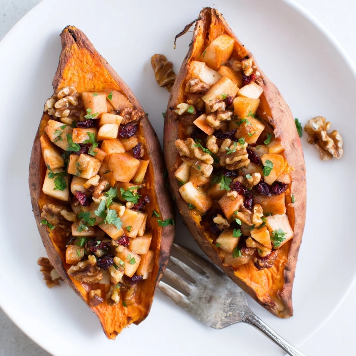 Baked Stuffed Sweet Potatoes With Apples split open, apple-walnut filling glistening
