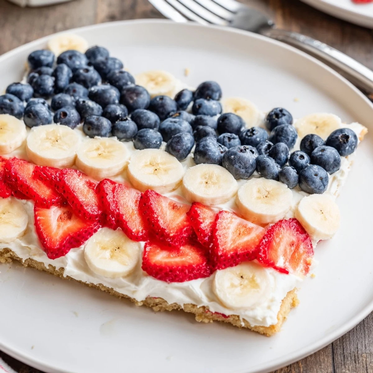 Close-up of American Flag Fruit Pizza ready to slice, sweet aroma.