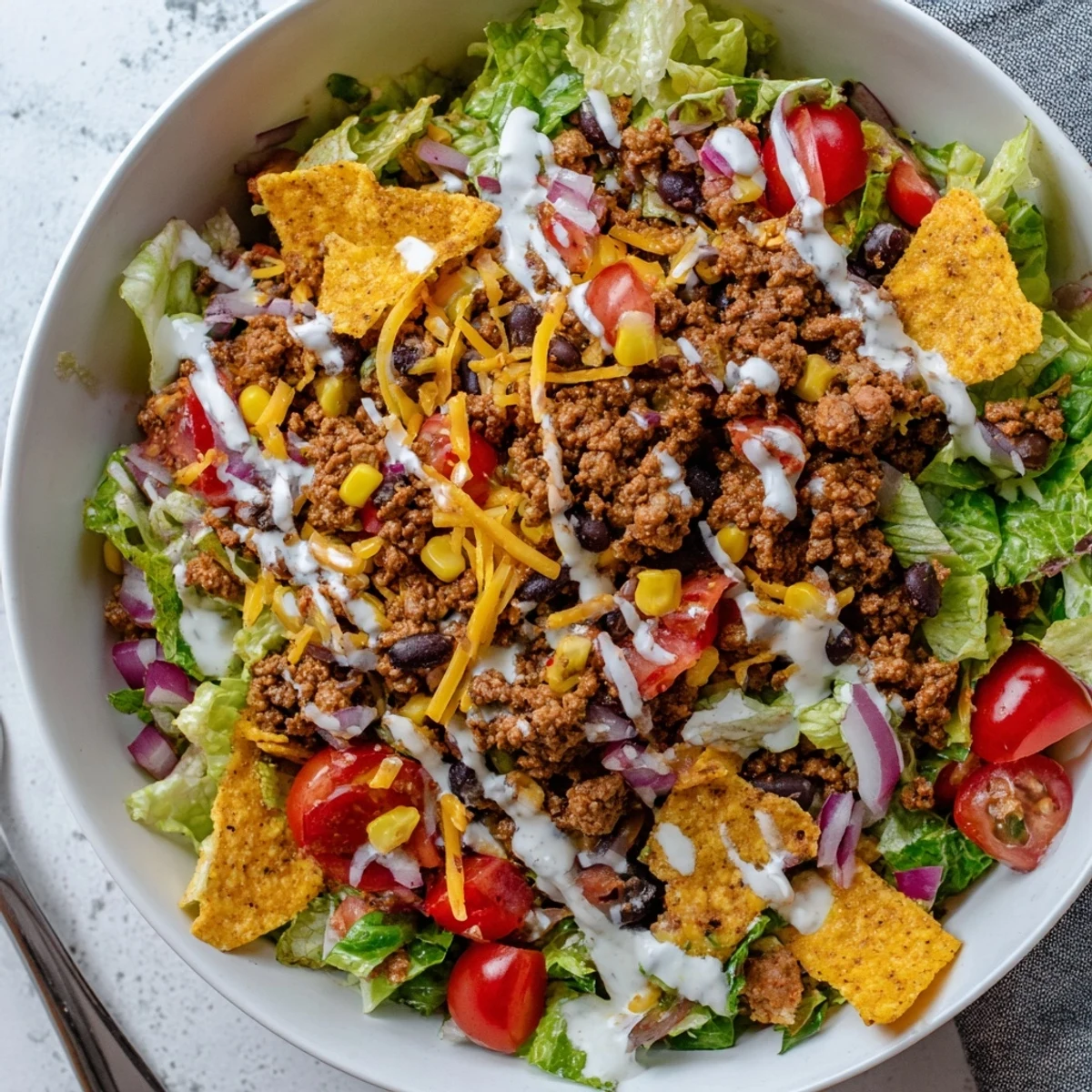 Bowl of Simple Doritos Taco Salad with warm seasoned beef, tangy dressing