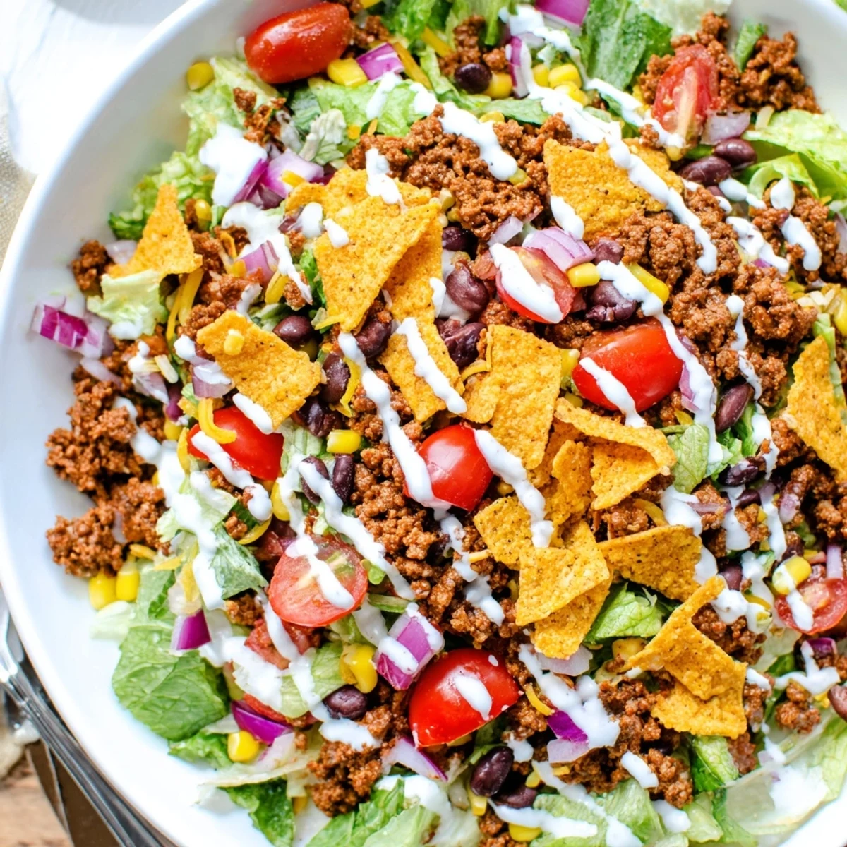 Simple Doritos Taco Salad piled high with crunchy chips and melted cheddar