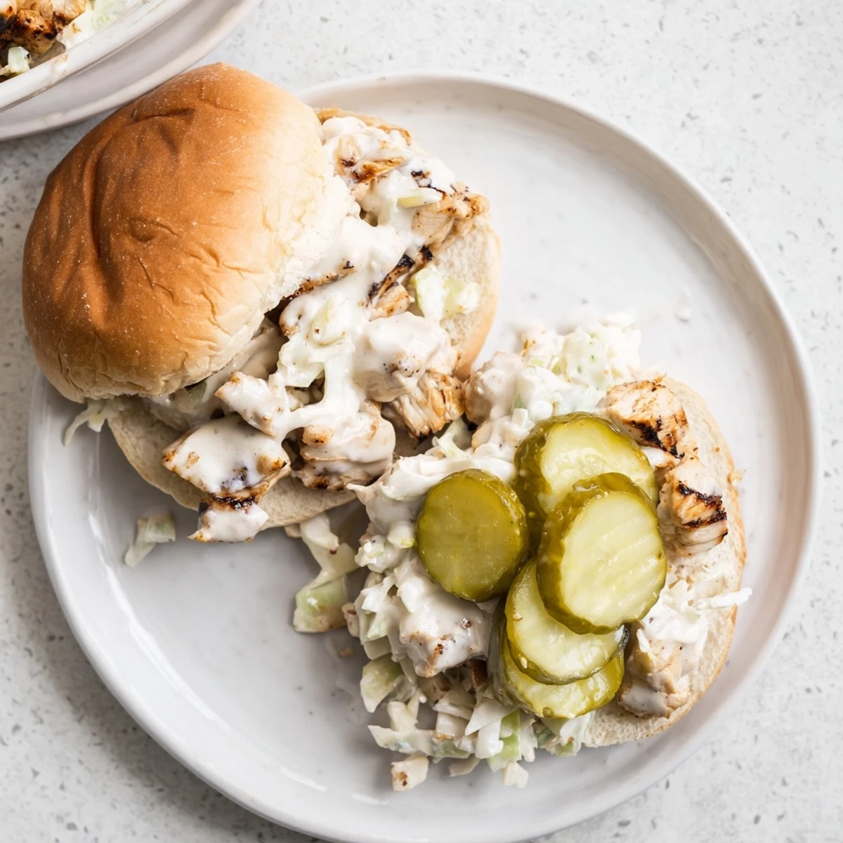 Saucy Alabama white BBQ chicken sandwich piled high on a soft bakery-style bun