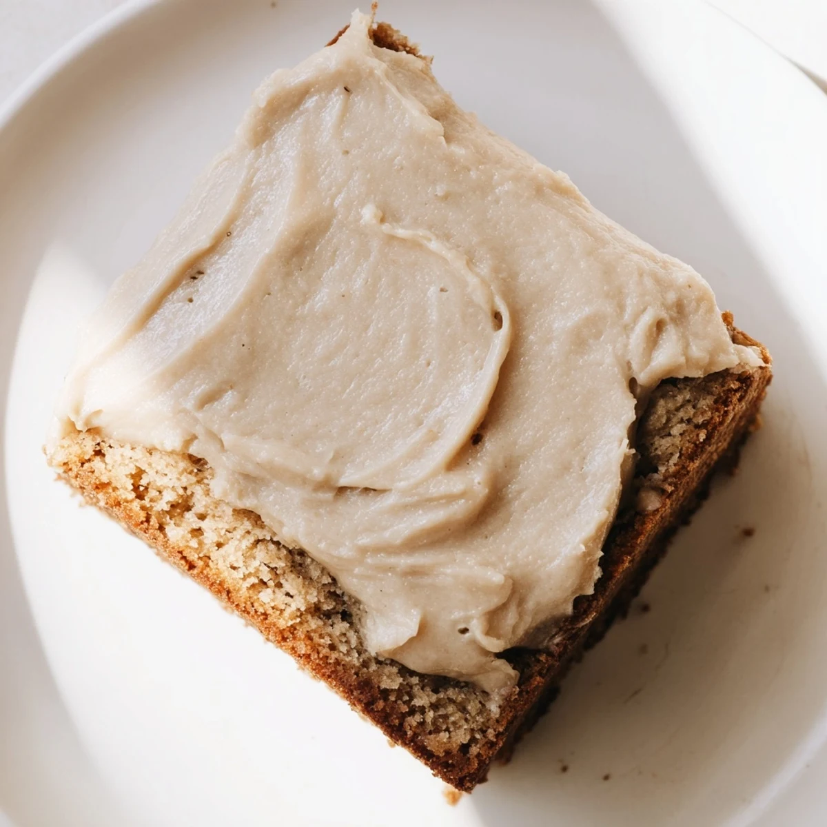 Golden banana bread brownies bars crowned with caramelized brown butter frosting ready for serving