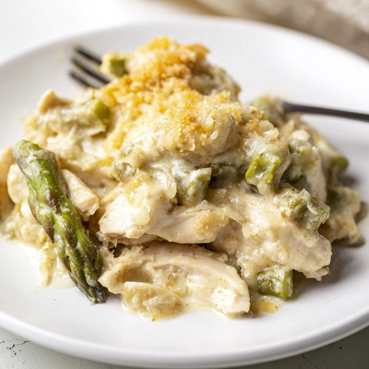 Creamy Chicken Asparagus Bake bubbling with golden cheese, tender chicken and bright asparagus.