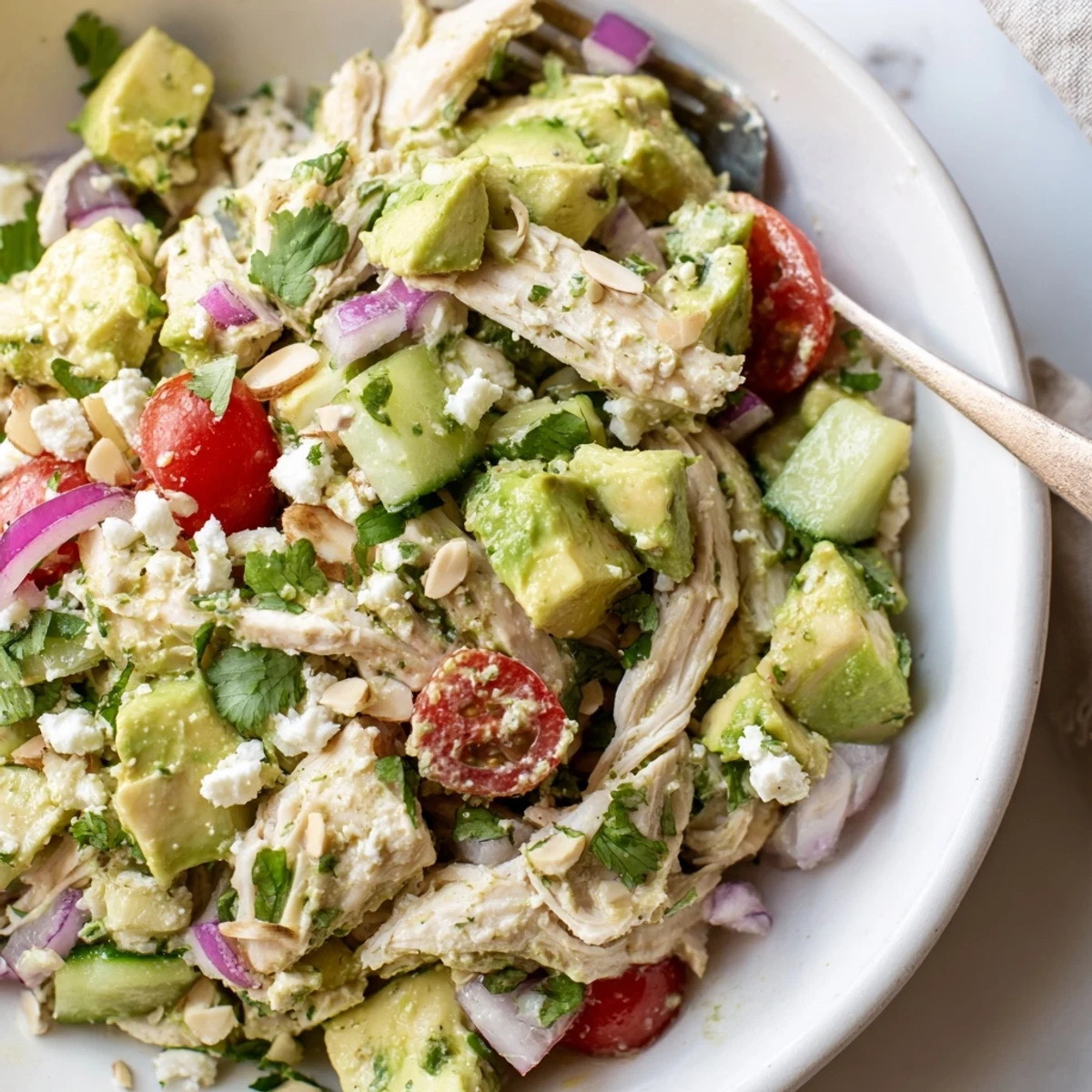 Bright Avocado Chicken Salad served in lettuce cups, juicy tomatoes, cilantro