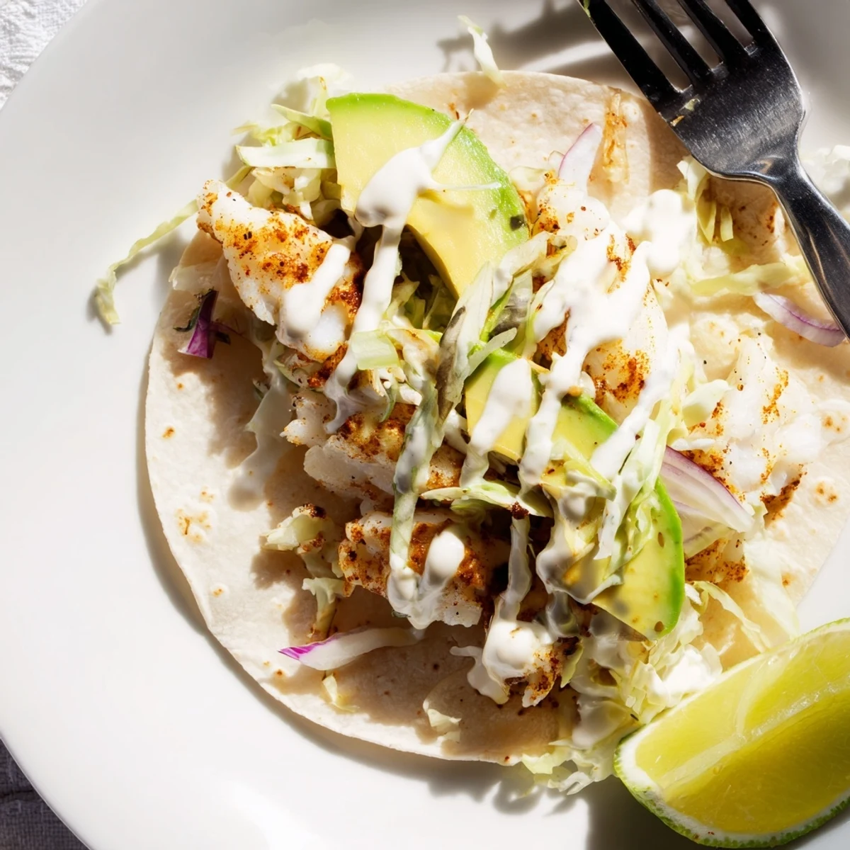 Baked Cod Fish Tacos with Creamy Cilantro Lime Sauce, flaky cod and crisp slaw