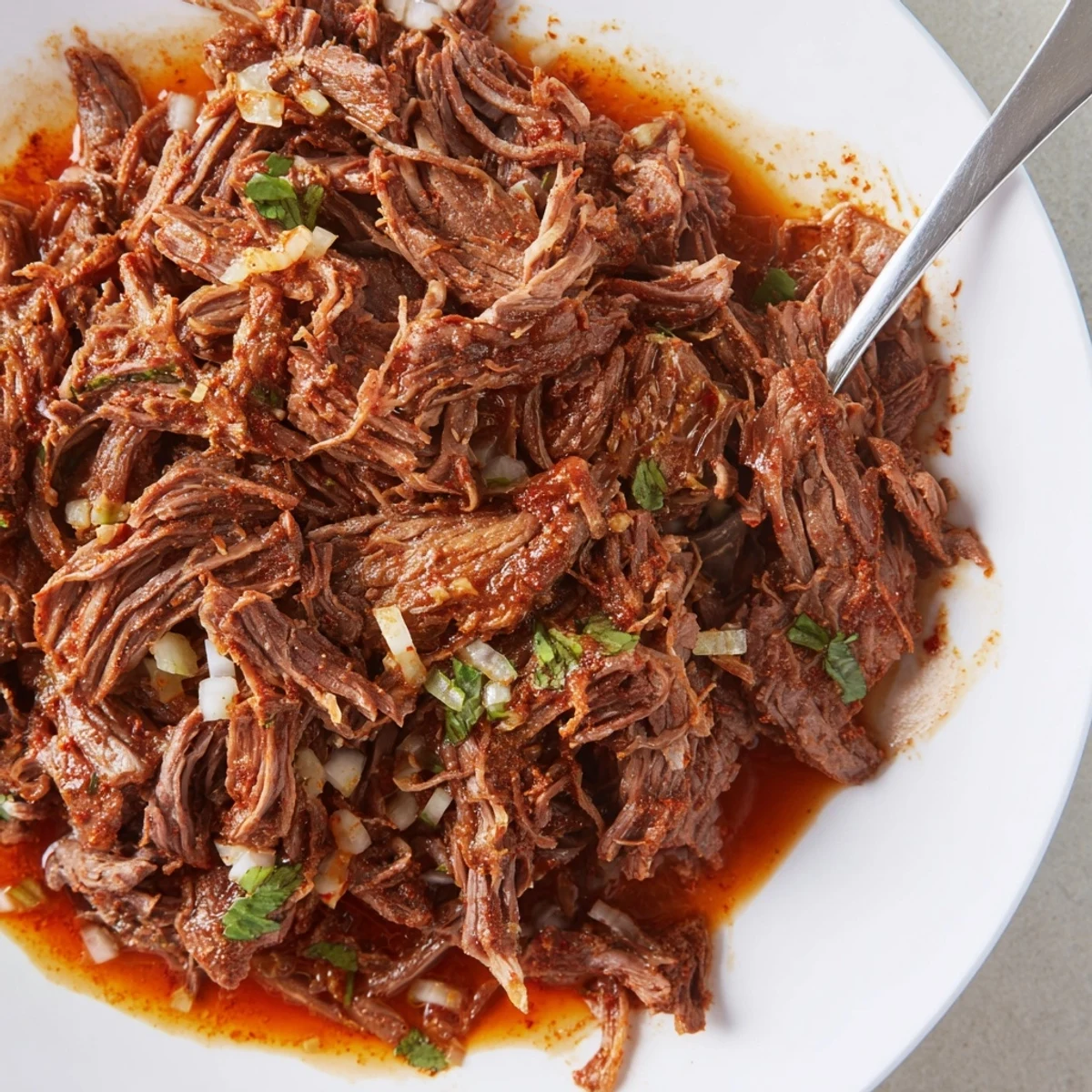 Slow Cooker Beef Barbacoa, tender shredded beef steaming with smoky chipotle aroma  