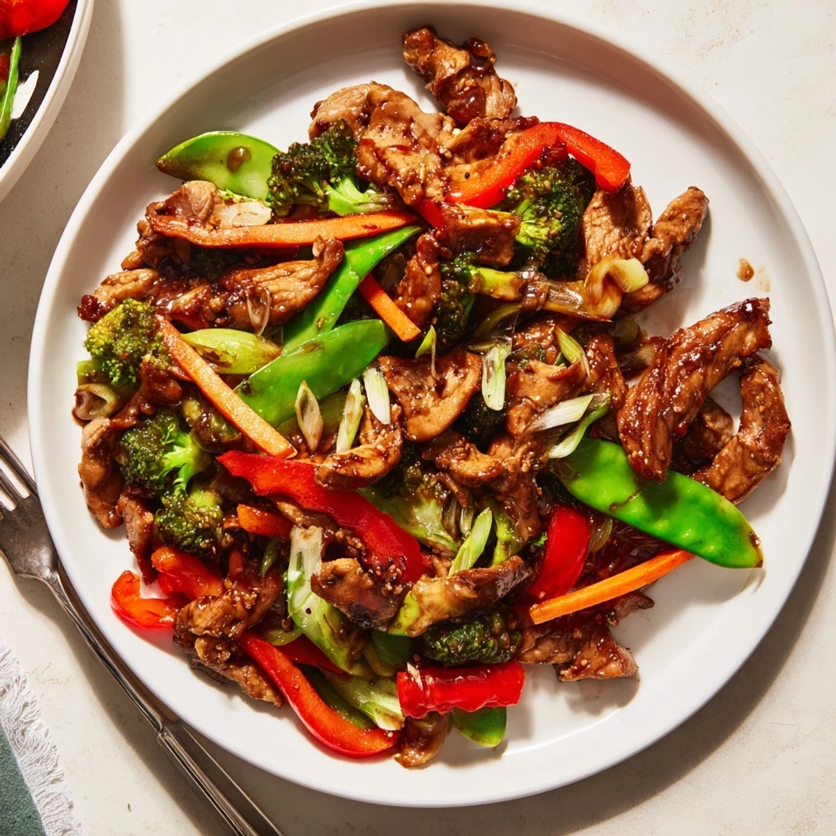 Tender sliced Hunan Chicken tossed with vibrant bell peppers and crisp broccoli florets