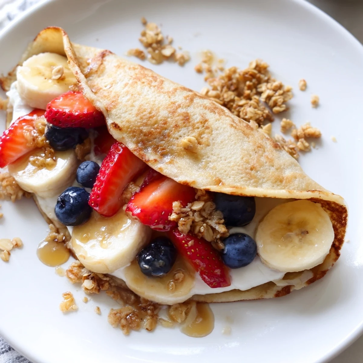 Fluffy pancake tacos folded and stuffed with creamy Greek yogurt and ripe banana slices