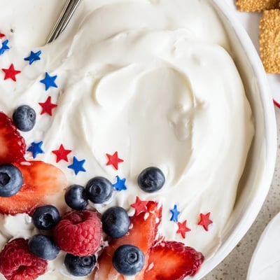 Star Spangled Cheesecake Dip arranged in a shallow dish, served with graham crackers